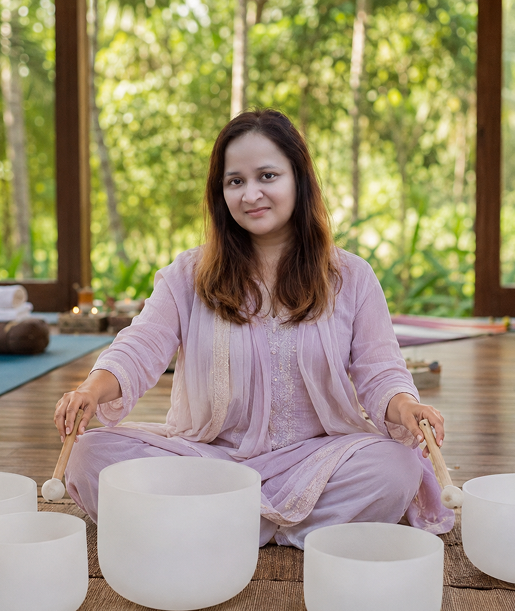 Eti Gupta facilitating a group sound healing session with crystal bowls